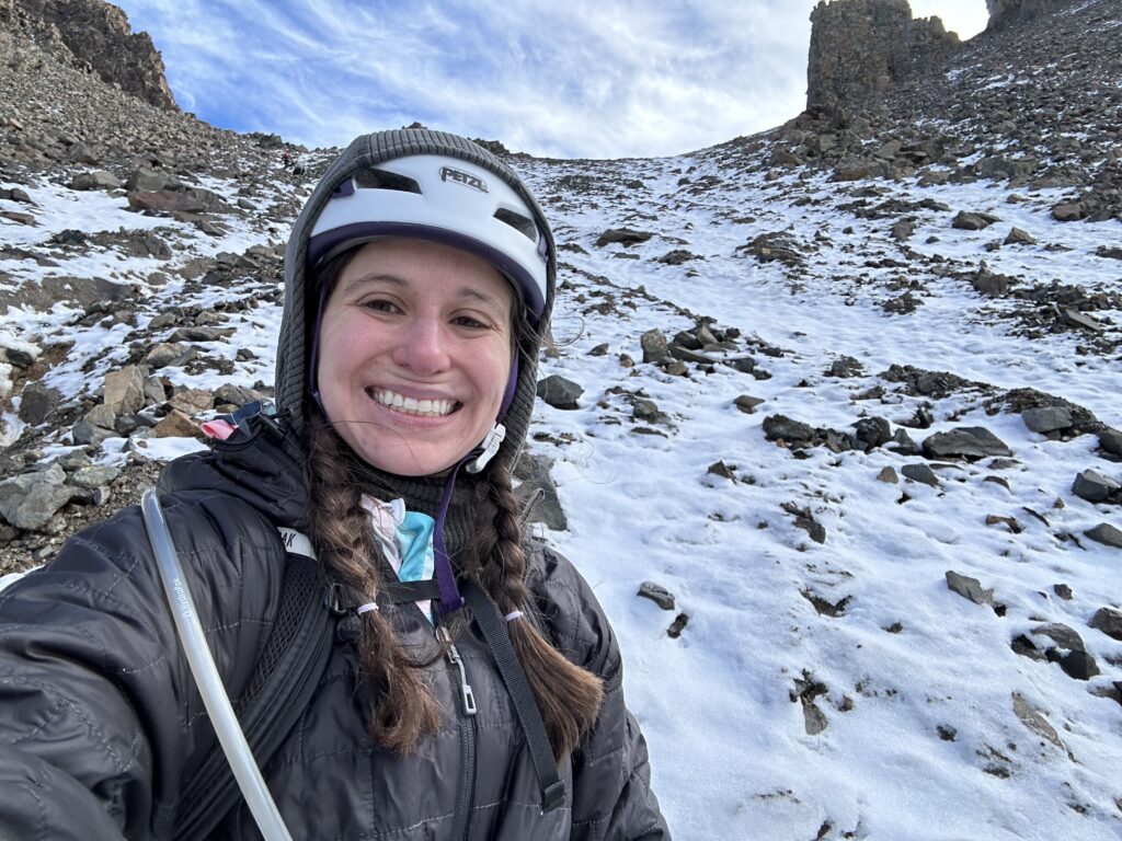 Lai smiling in a selfie with the gully above her on Mount Sneffels