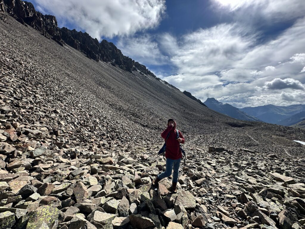 Jon eating an apple on the scree field 